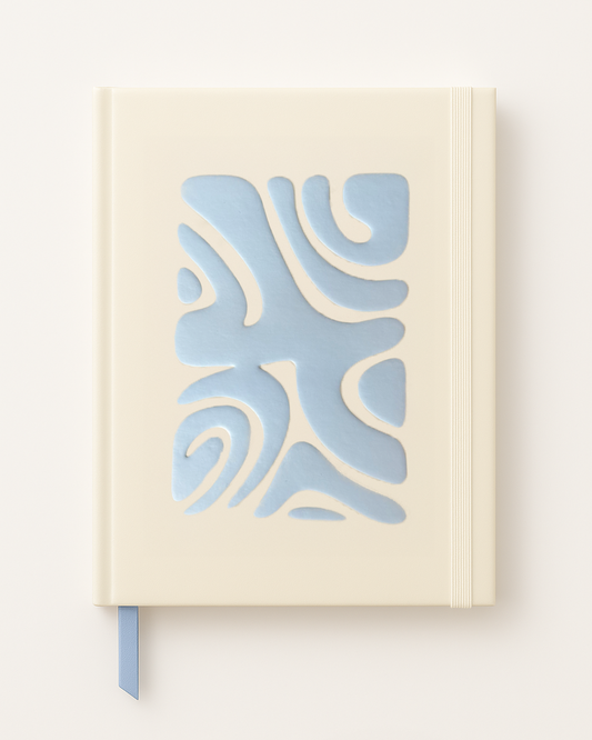 Notebook with a blue abstract design on a beige cover against a white background