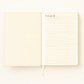 Open notebook with lined pages on a white background